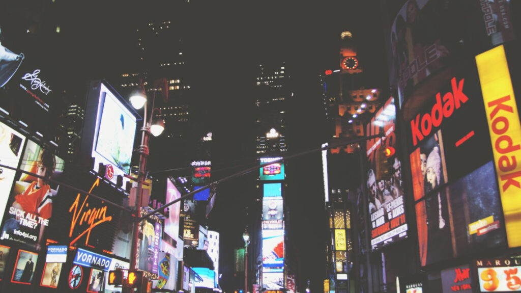 City at night with neon lights lighting up the area.