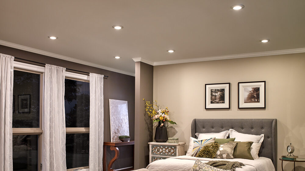 Bedroom with pot lights installed into the ceiling that are dimmable and come with smart controls. 