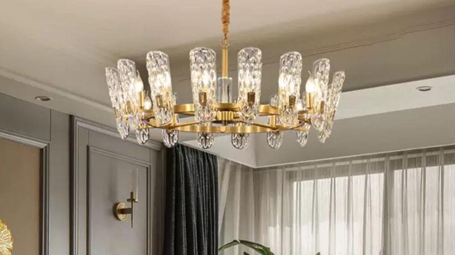 A glass and gold chandelier installed by a residential electrician hanging in the living room of a residential house.