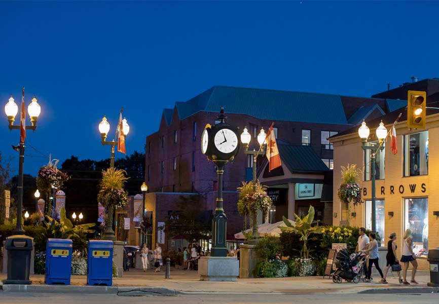 Oakville City center on a summer night with people walking by.