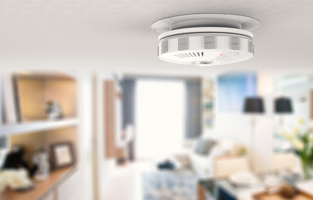 Smoke alarm mounted on a home ceiling