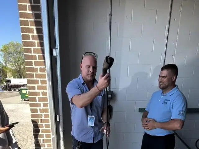 3E Electrical technician holding an EV charging cable