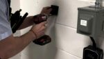 3E electrician drilling at an electrical panel during an upgrade in Toronto