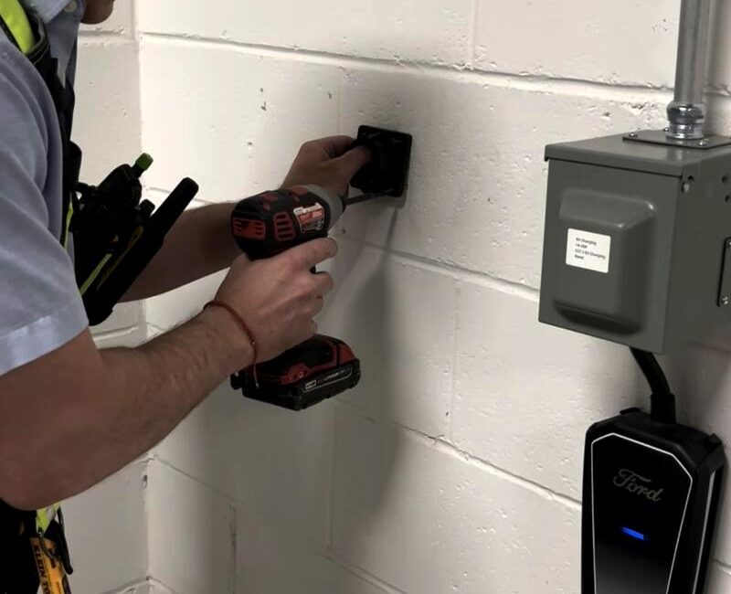 3E electrician drilling at an electrical panel during an upgrade in Toronto
