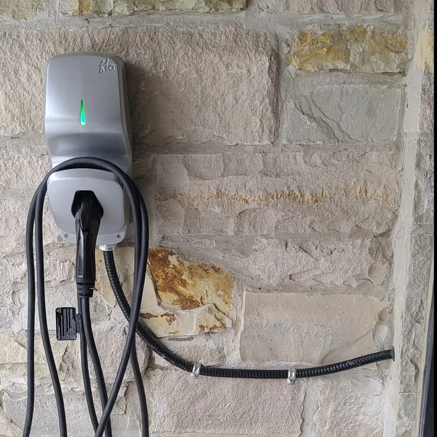 EV charger installation by 3e Electrical — silver FLO charger mounted on a stone wall