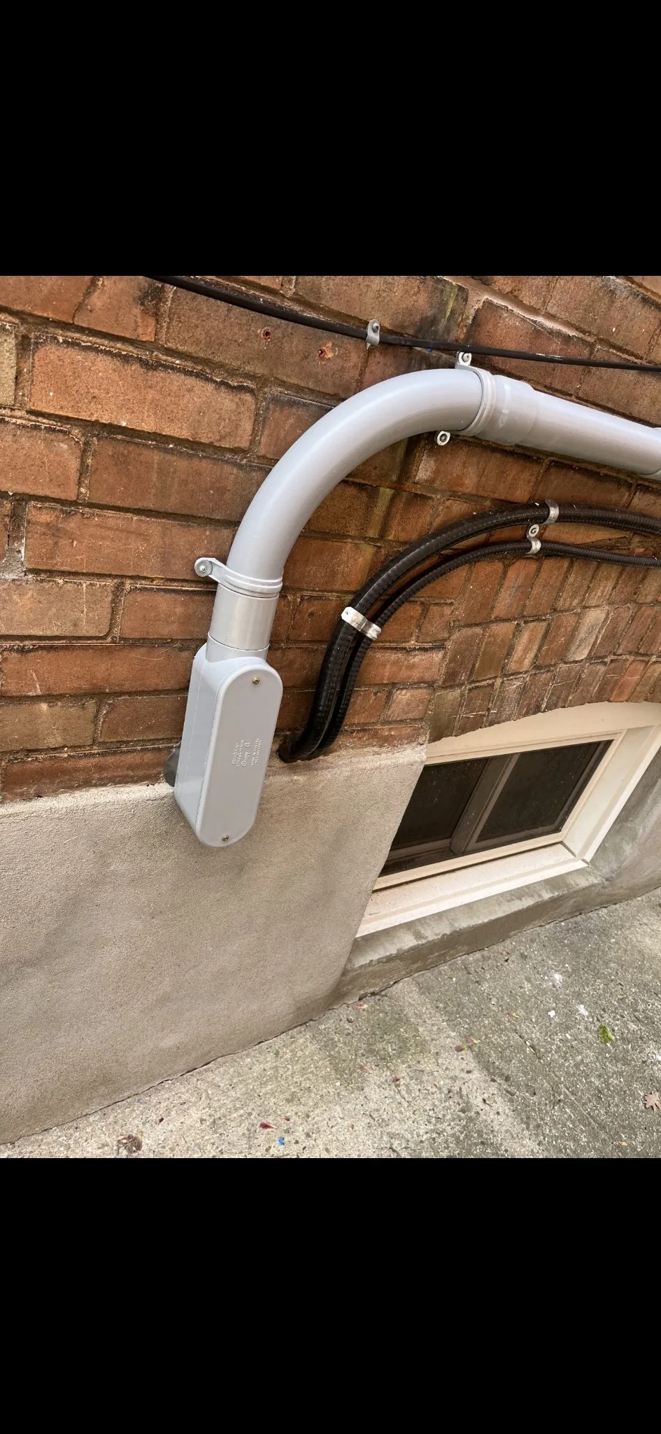 3e project — TECK armoured cable strapped to a brick wall