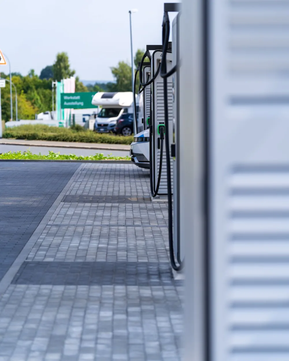 A row of DC fast chargers at an outdoor charging station