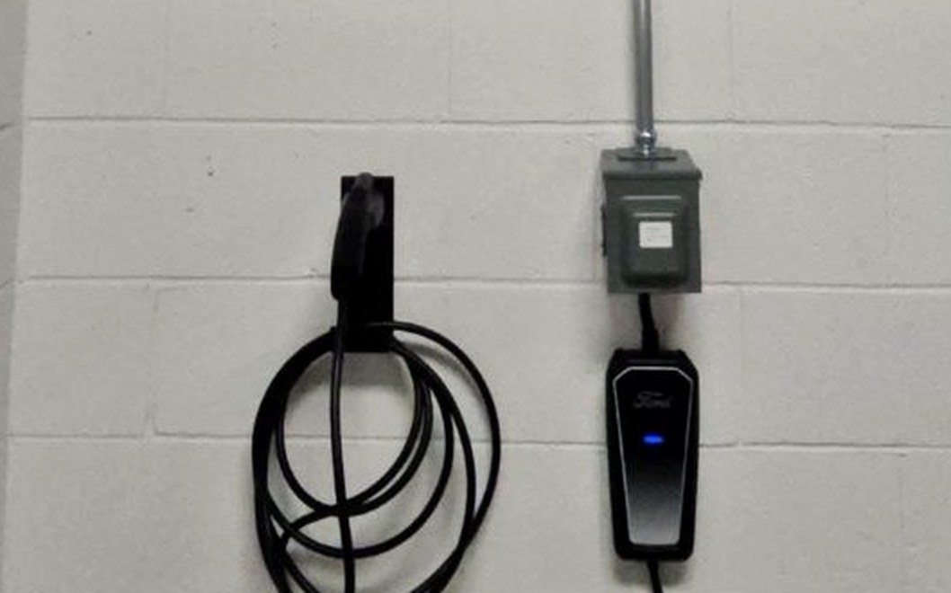 Level 2 fleet EV charger installed on a facility wall