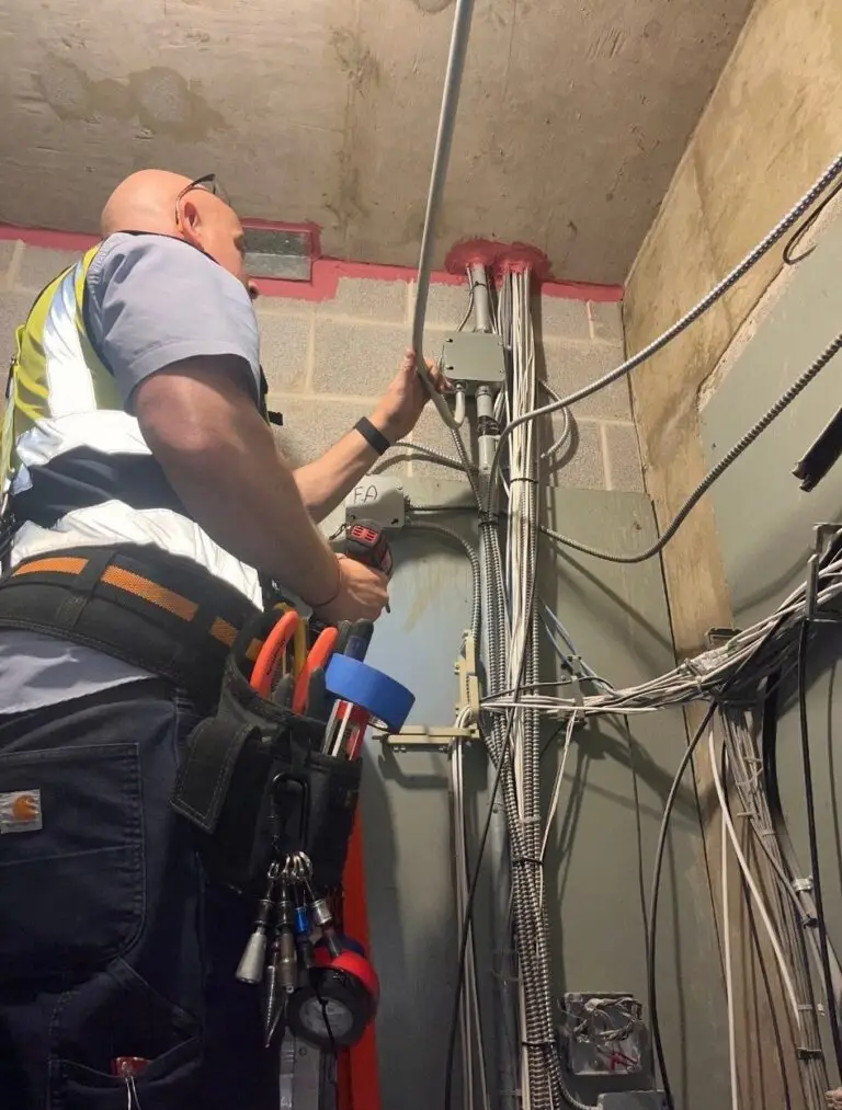 3e Electrical technician working on a commercial electrical panel